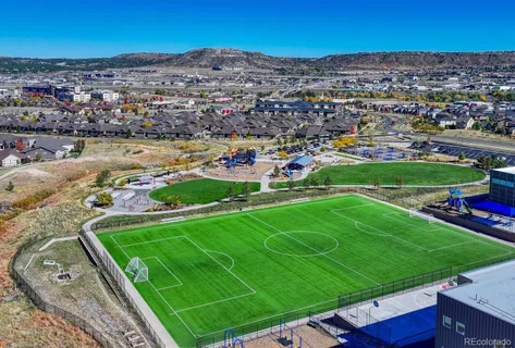 an aerial view of a house with a yard and lake view