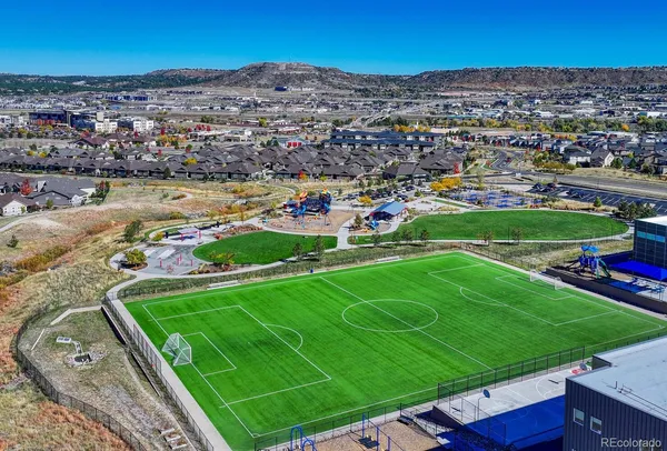 an aerial view of a house with a yard and lake view
