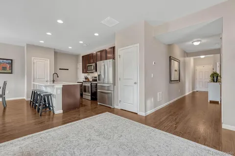 a view of kitchen with dining room and wooden floor