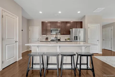 a kitchen with kitchen island cabinets and chairs