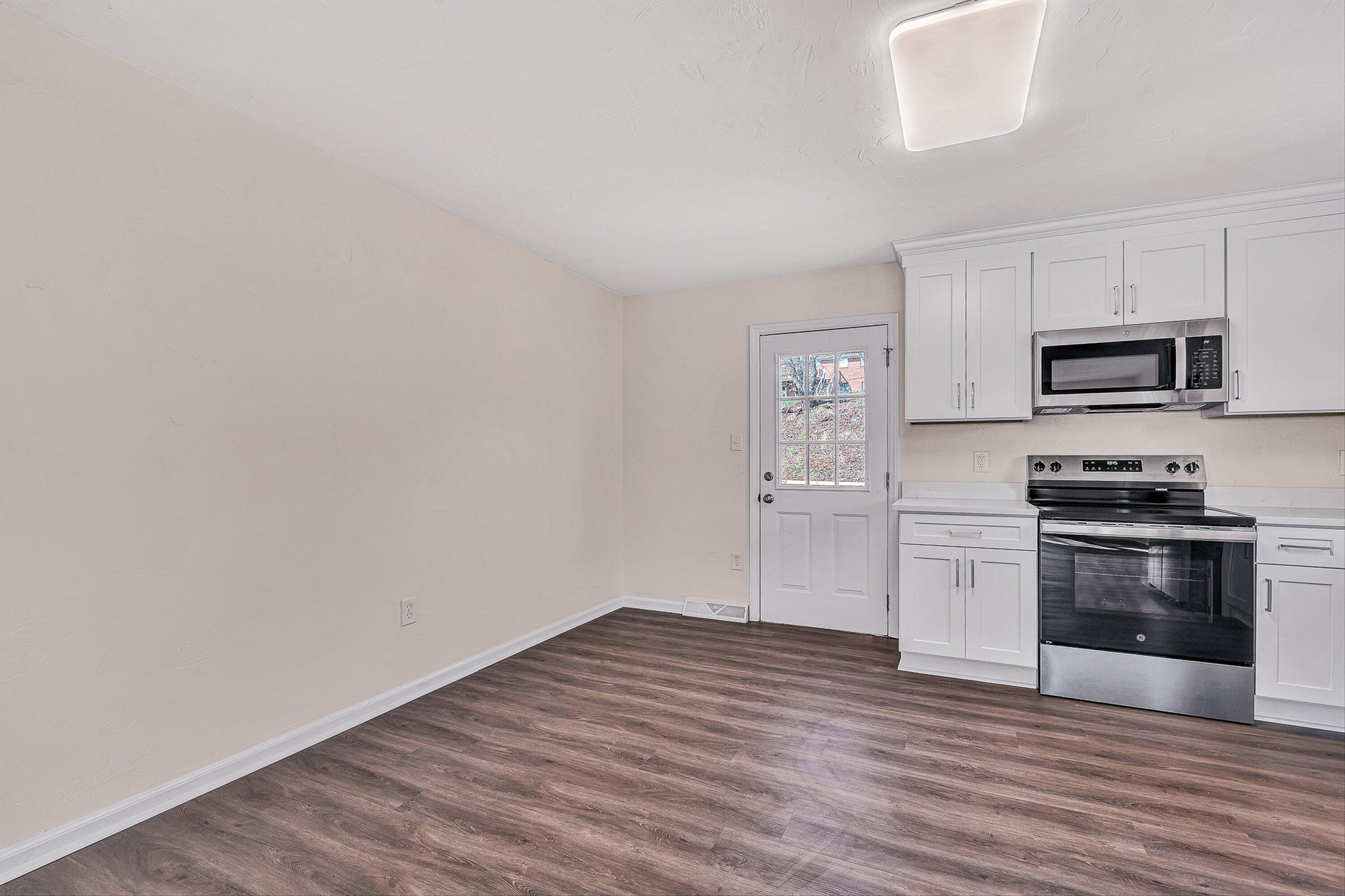 736 Ramada Road Vinton, VA 24179 - Photo 11 of 37 a kitchen with granite countertop a refrigerator and a stove top oven