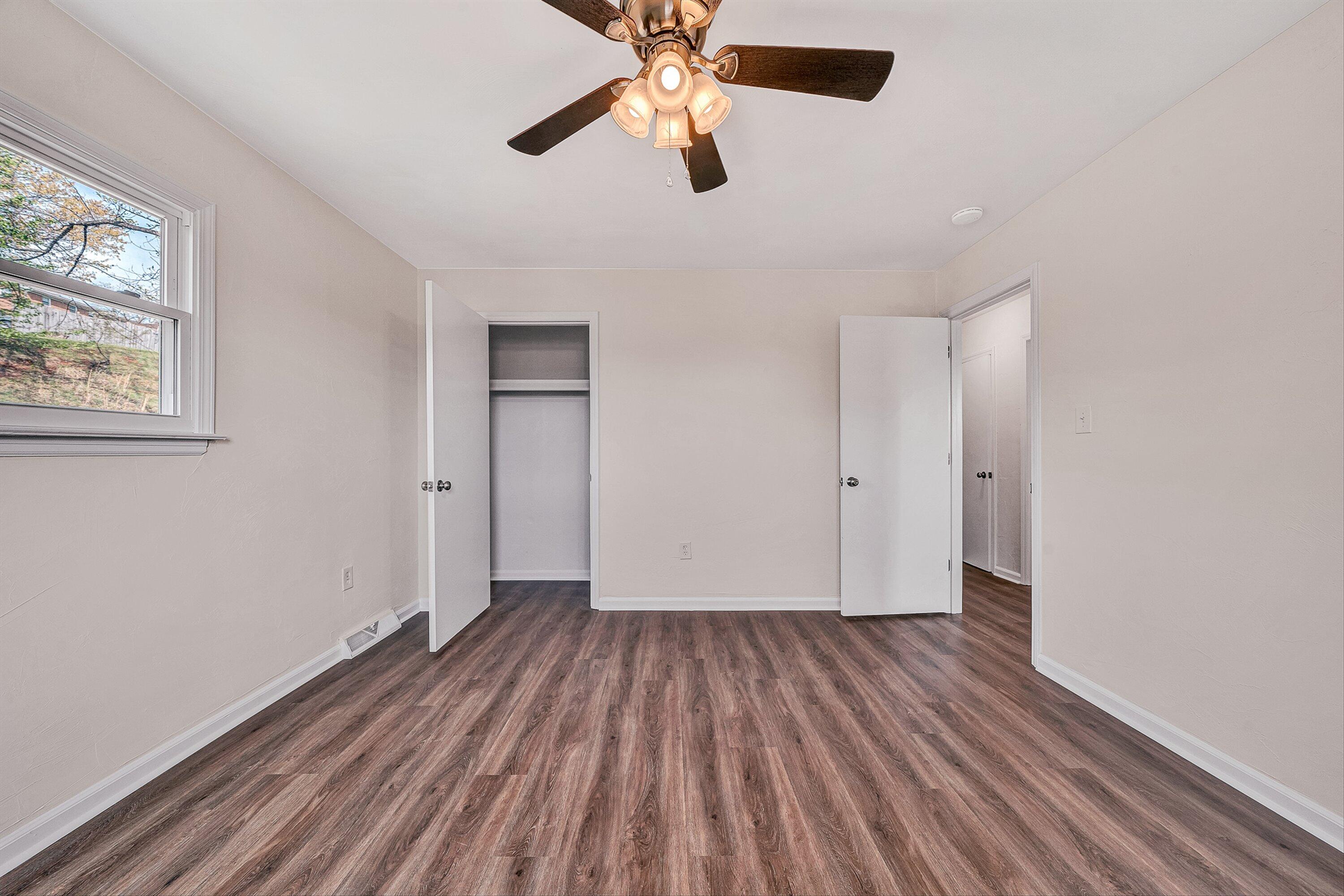 736 Ramada Road Vinton, VA 24179 - Photo 15 of 37 wooden floor in an empty room with a window