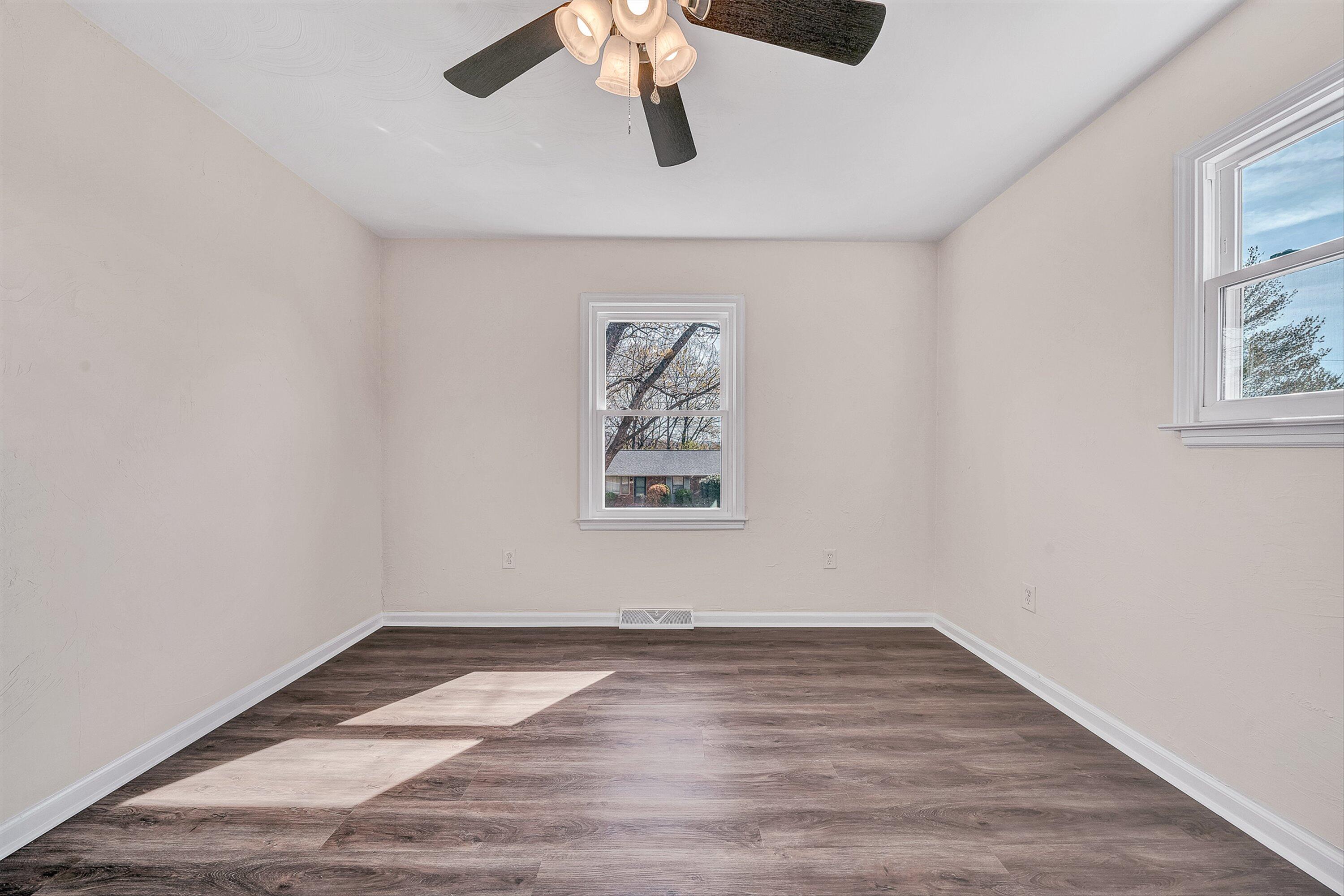 736 Ramada Road Vinton, VA 24179 - Photo 18 of 37 a view of an empty room with wooden floor and window