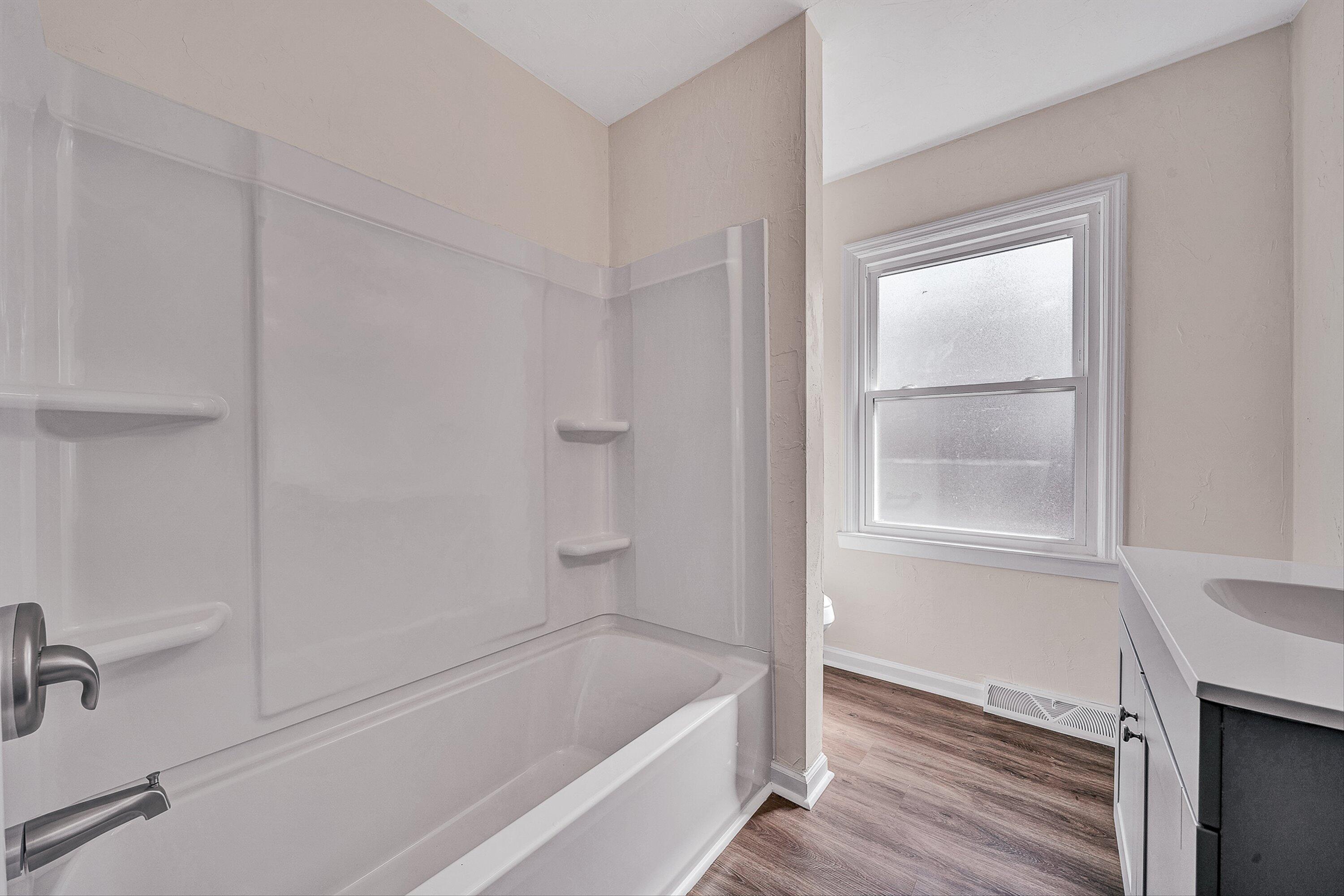 736 Ramada Road Vinton, VA 24179 - Photo 21 of 37 a bathroom with a bathtub and a window