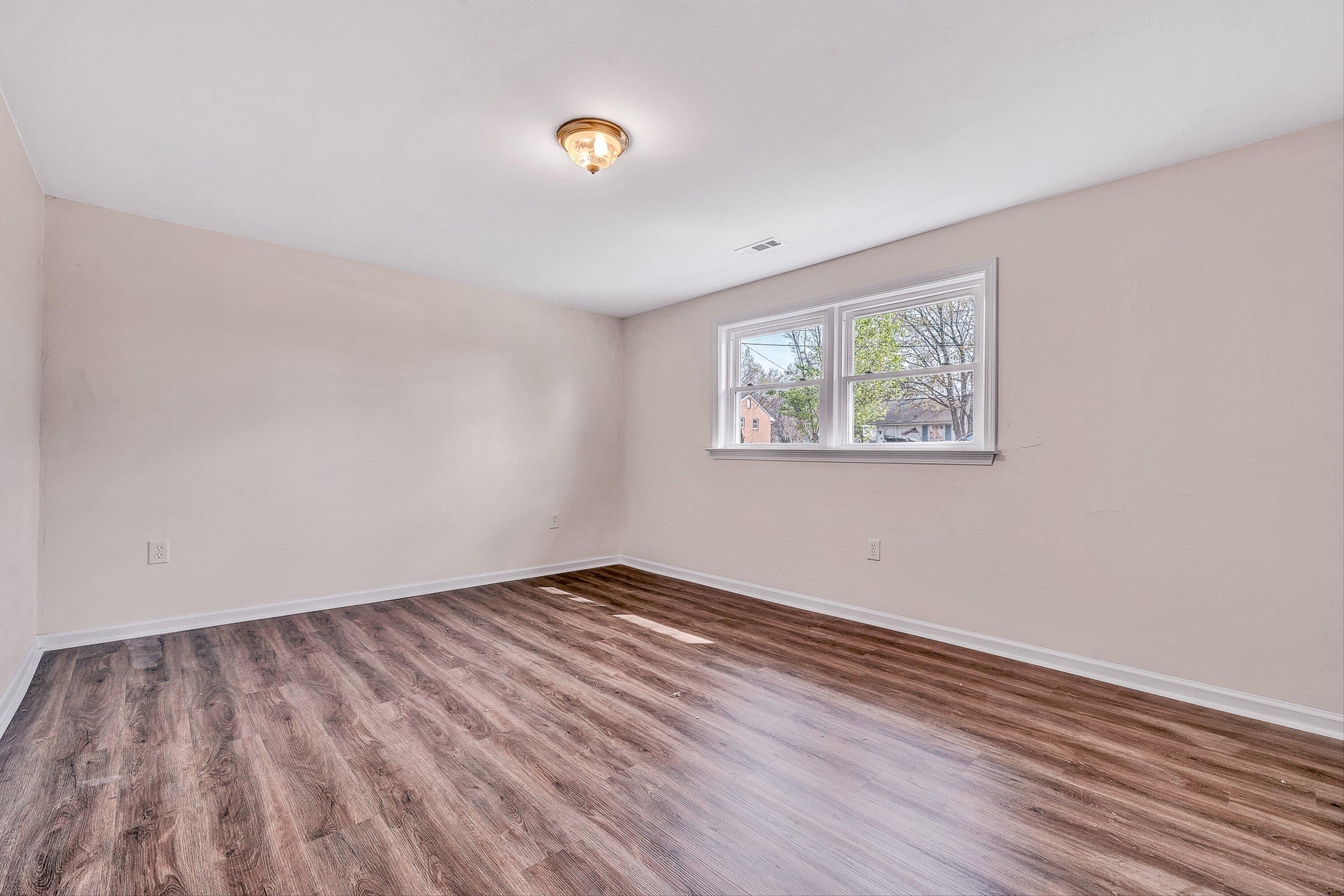 736 Ramada Road Vinton, VA 24179 - Photo 23 of 37 an empty room with wooden floor and windows