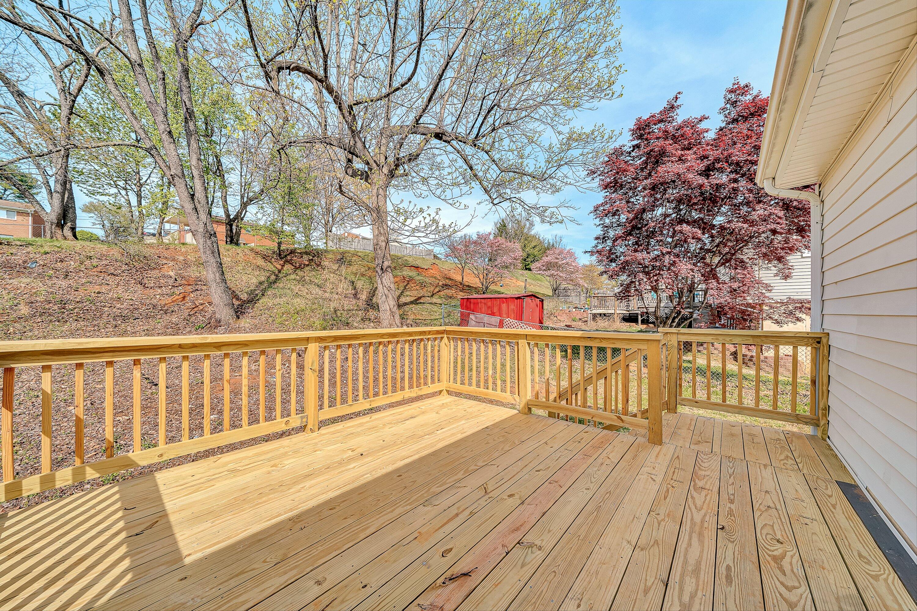 736 Ramada Road Vinton, VA 24179 - Photo 34 of 37 a balcony with wooden floor and trees