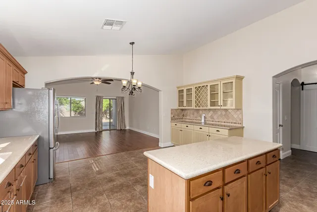 a kitchen with a sink a counter top space and stainless steel appliances