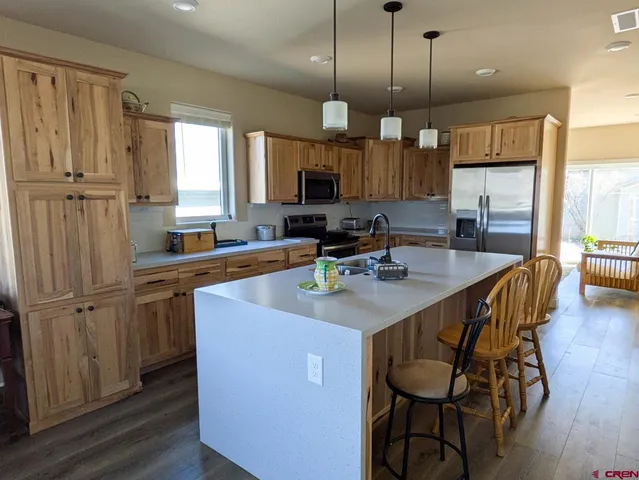 a kitchen with sink cabinets and wooden floor