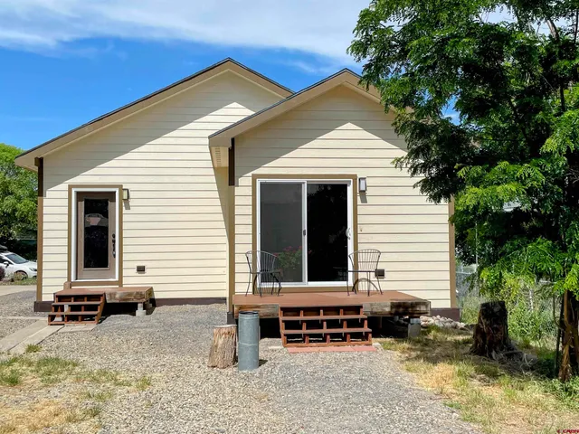 a front view of a house with sitting area