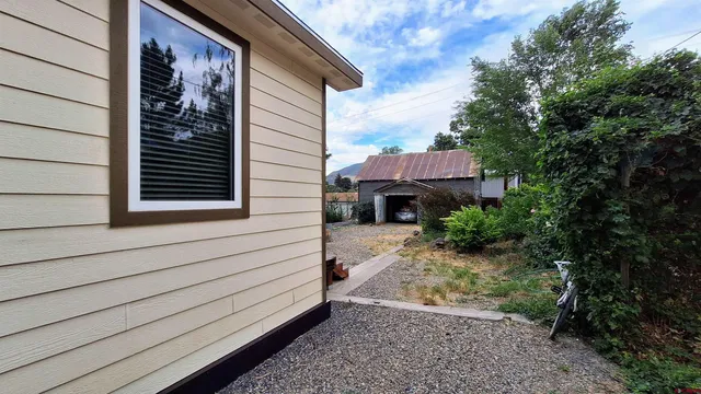 a pathway of a house with a yard