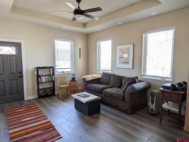 a living room with furniture and a wooden floor