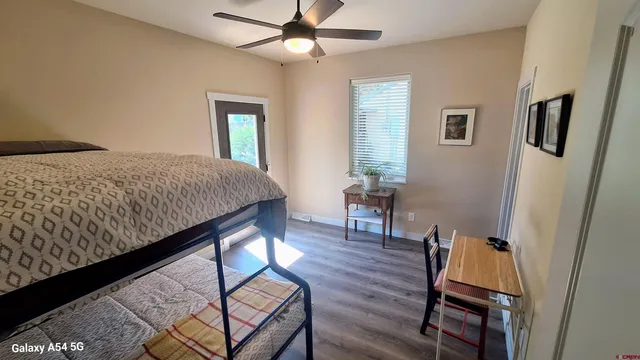 a bedroom with bed and wooden floor