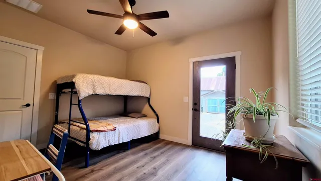 a bedroom with bed and a potted plant