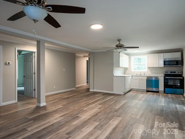 a view of a kitchen with a stove cabinets and wooden floor