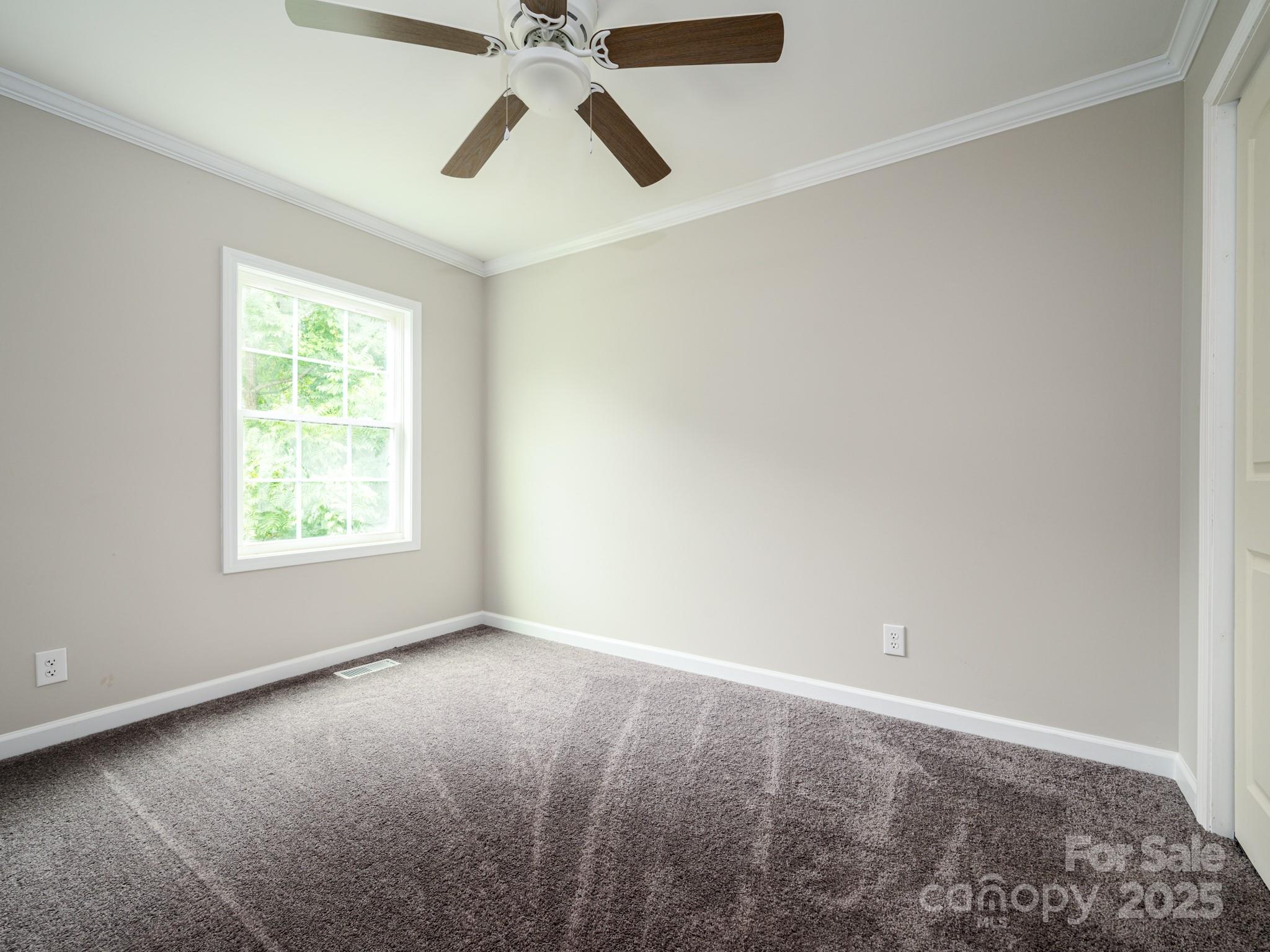 6458 Hudlow Road Union Mills, NC 28167 - Photo 10 of 16 an empty room with windows and fan