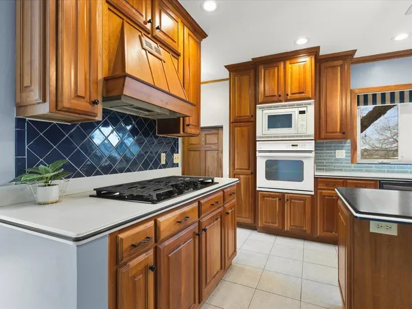 a kitchen with stainless steel appliances granite countertop a stove and a microwave