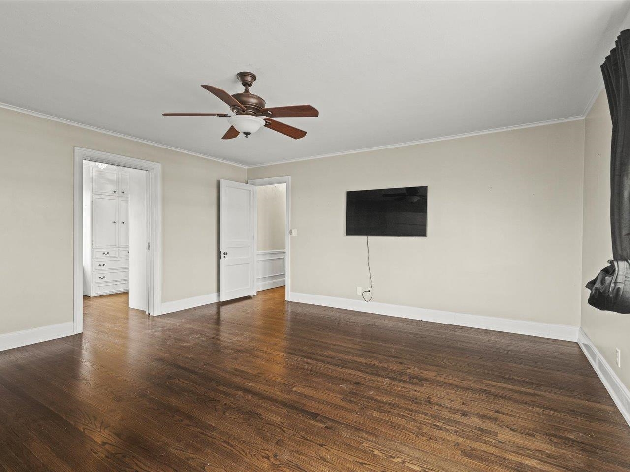2014 Glenview Road Rockford, IL 61107 - Photo 15 of 82 a view of an empty room with wooden floor and a ceiling fan