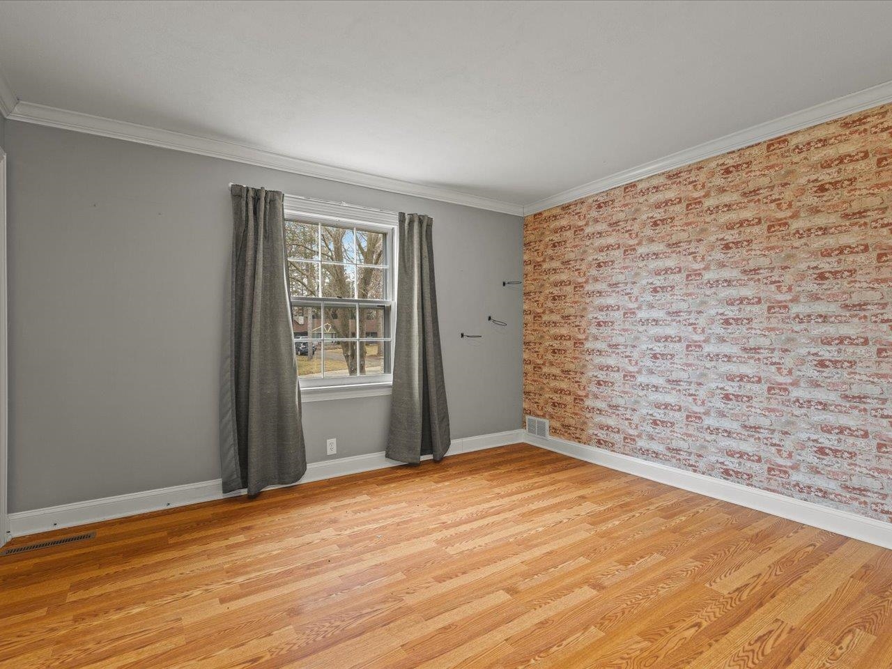 2014 Glenview Road Rockford, IL 61107 - Photo 49 of 82 a view of an empty room with wooden floor and a window