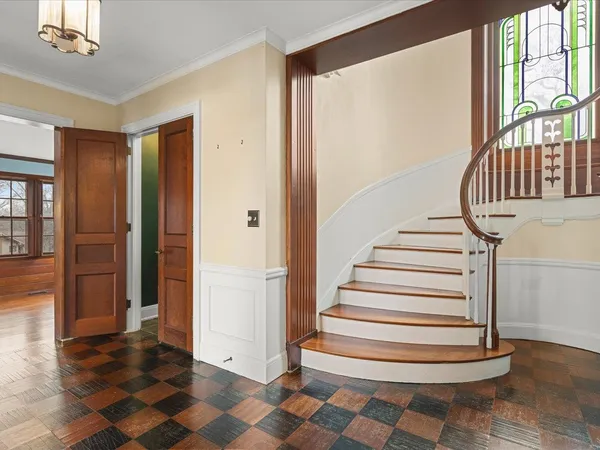 a view of hallway with stairs and wooden floor