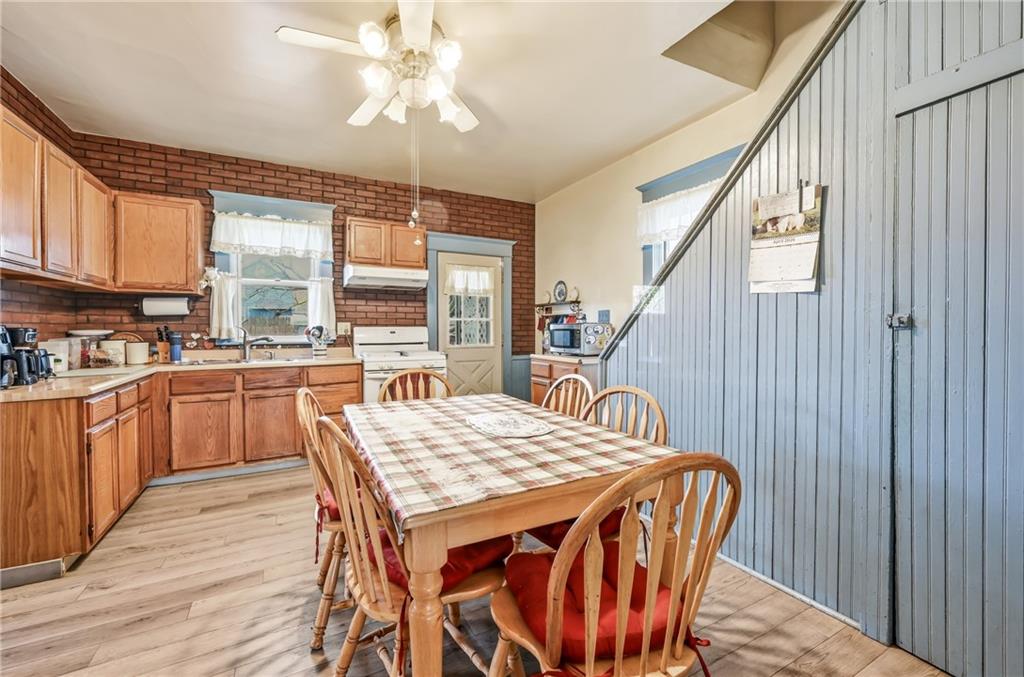 753 Spruce Avenue Sharon, PA 16146 - Photo 15 of 31 a kitchen with a table chairs stove and refrigerator