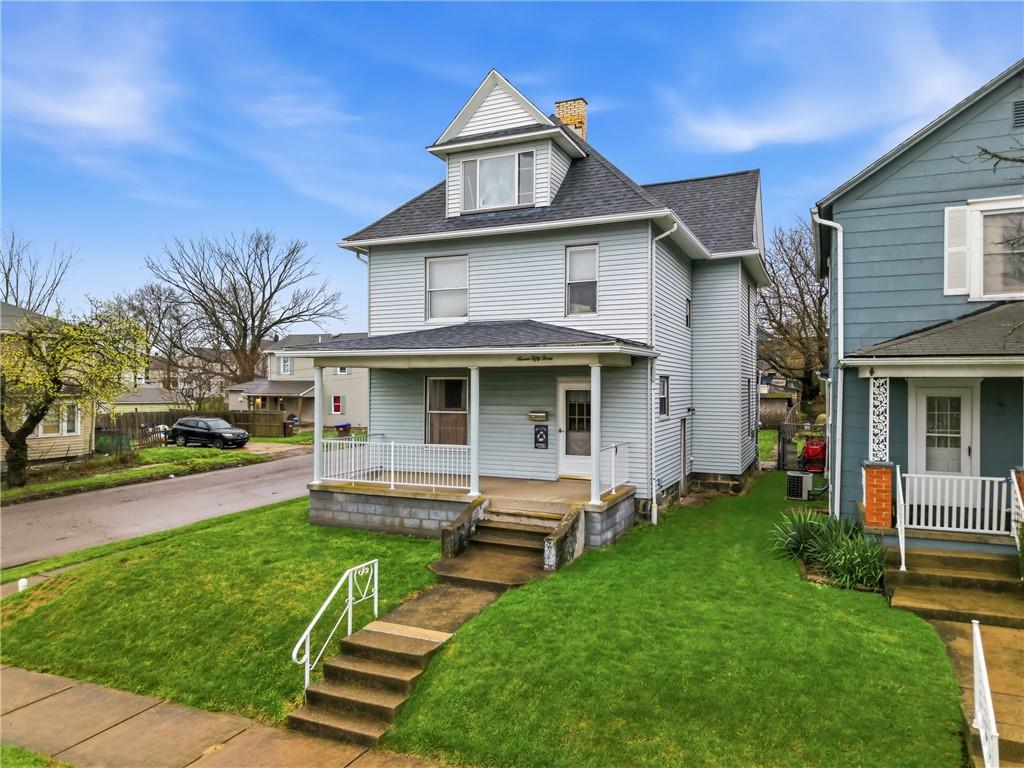 753 Spruce Avenue Sharon, PA 16146 - Photo 3 of 31 a front view of a house with a yard table and chairs