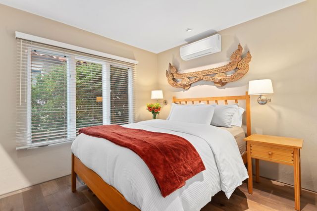 a bathroom with a granite countertop sink a toilet a mirror and shower