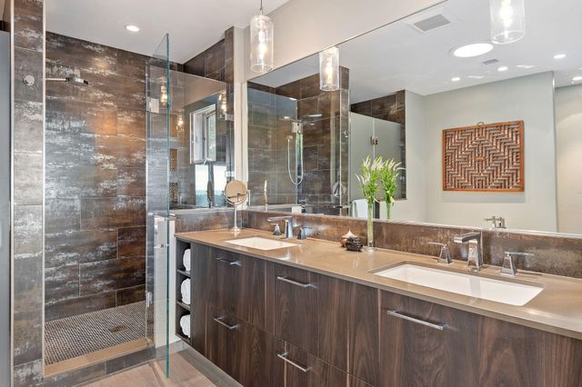 a bathroom with double sink and a mirror