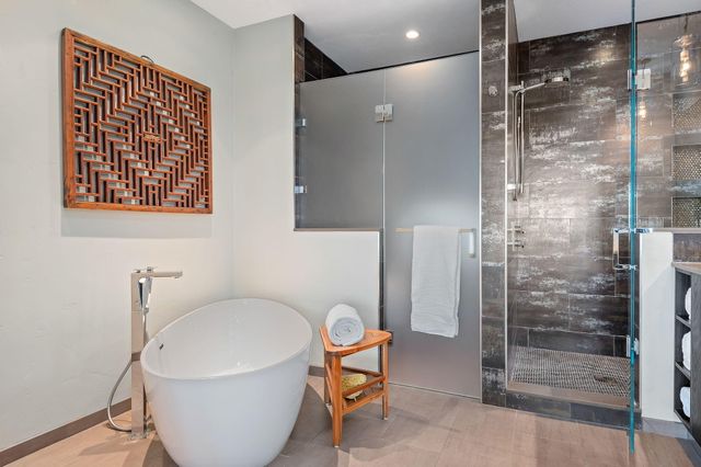 a bathroom with a bathtub and shower