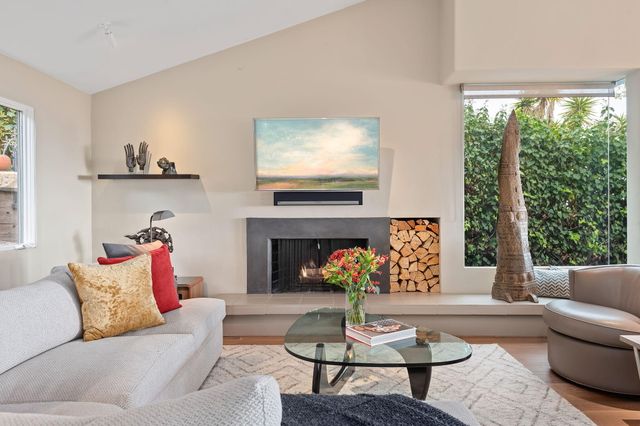 a living room with furniture a fireplace and window
