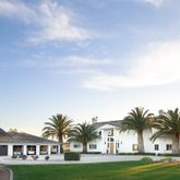 a front view of residential houses with yard and palm tree