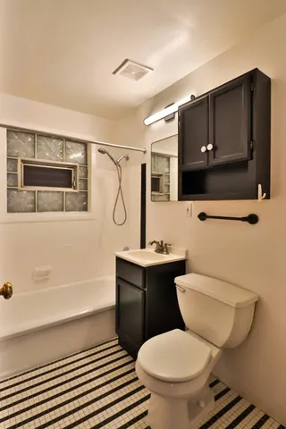 a bathroom with a toilet a sink and bathtub