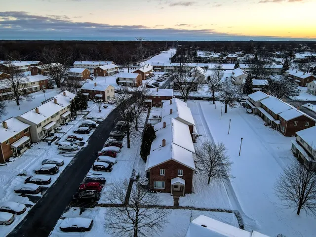an aerial view of residential houses with outdoor space
