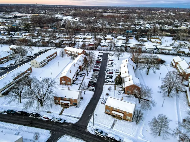 an aerial view of residential houses with outdoor space