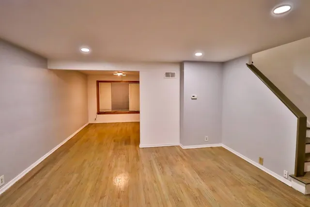 a view of hallway with wooden floor