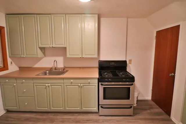 a kitchen with granite countertop a stove and a sink
