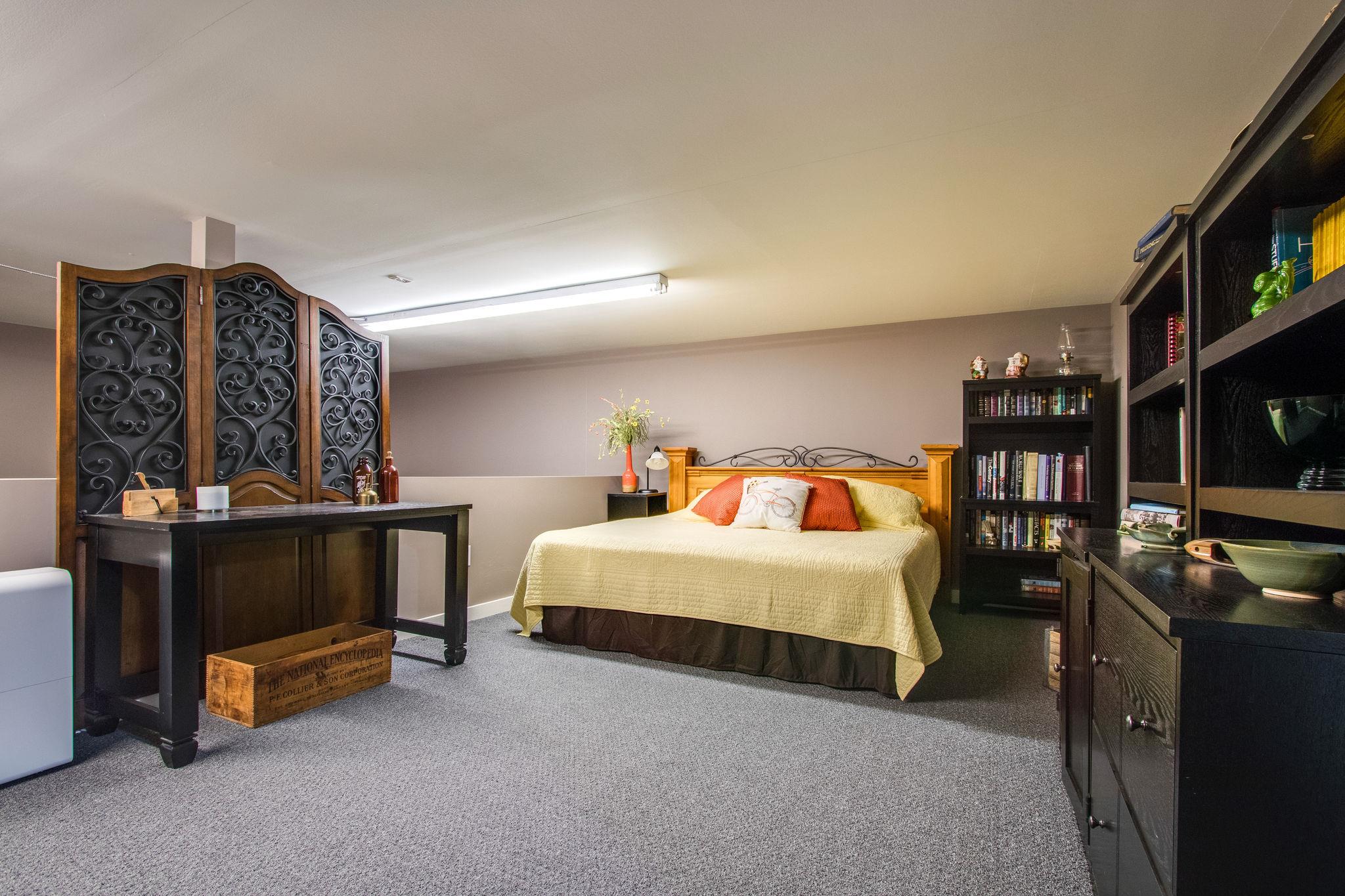 1922 Arlington Road Lebanon, TN 37087 - Photo 12 of 30 a bedroom with a bed a flat screen tv and gym equipment
