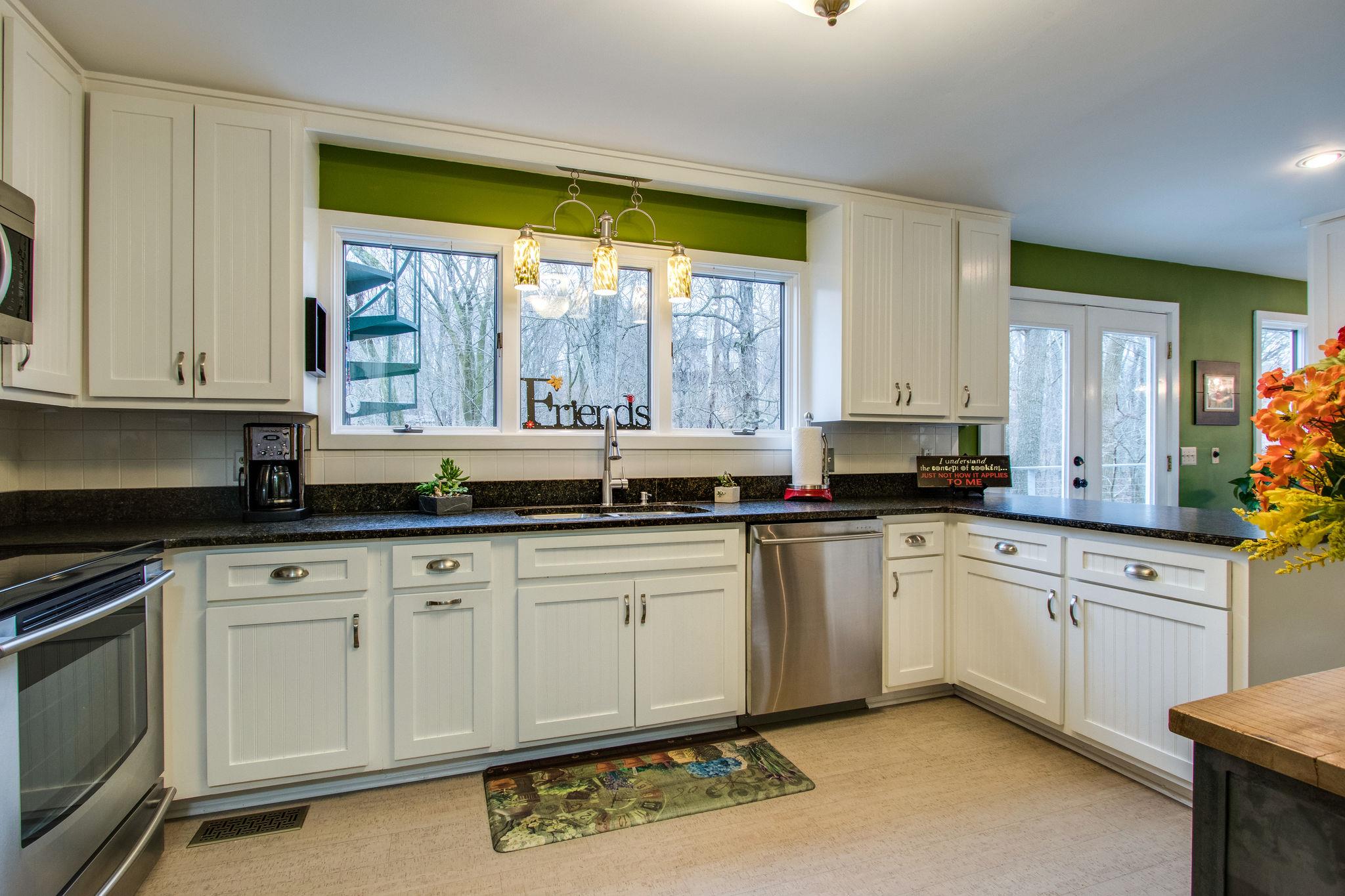 1922 Arlington Road Lebanon, TN 37087 - Photo 9 of 30 a kitchen with granite countertop a sink and white cabinets