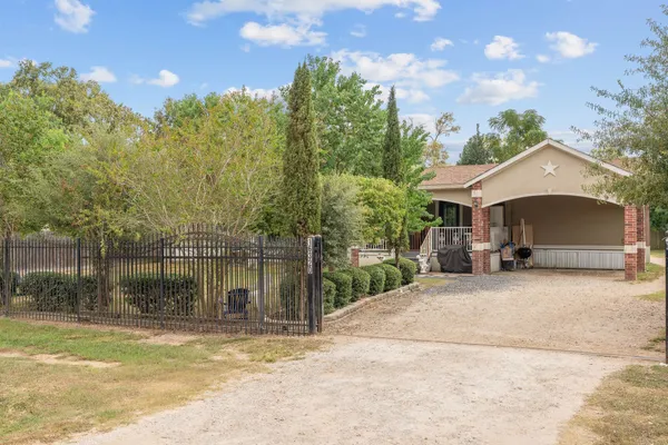 a view of a house with a yard and a patio