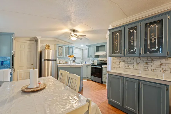 a kitchen with a refrigerator and a sink