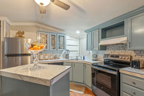 a kitchen with stainless steel appliances a sink stove and refrigerator