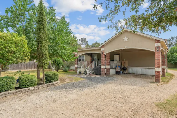a view of a house with a yard and garage