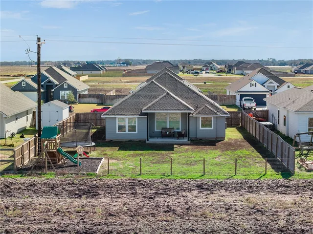 an aerial view of houses with outdoor space