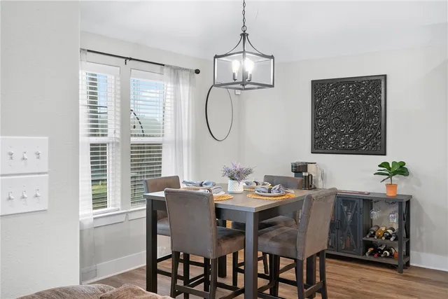 a dining room with furniture window and wooden floor