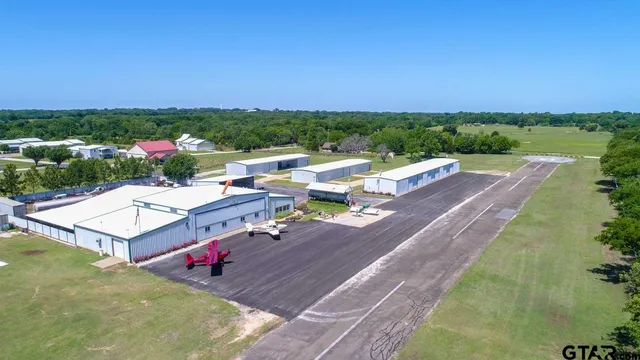 an aerial view of a house with yard swimming pool and outdoor seating
