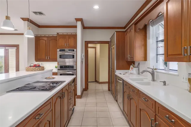 a kitchen with stainless steel appliances a sink stove and cabinets