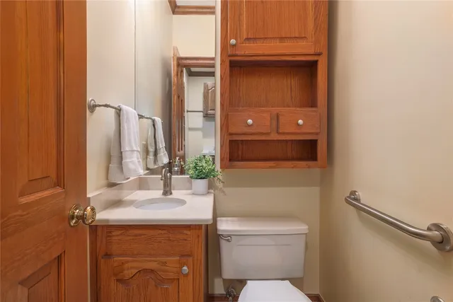 a bathroom with a toilet a sink and mirror