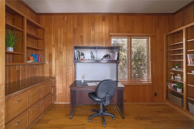 a view of a workspace with furniture and a window