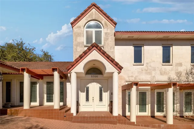 a view of a white house with a large windows