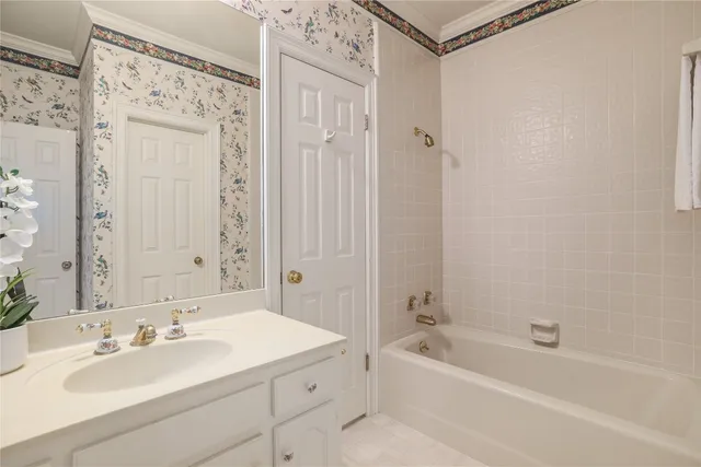 a bathroom with a tub sink and mirror