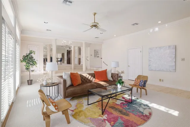 a living room with furniture a rug and a chandelier